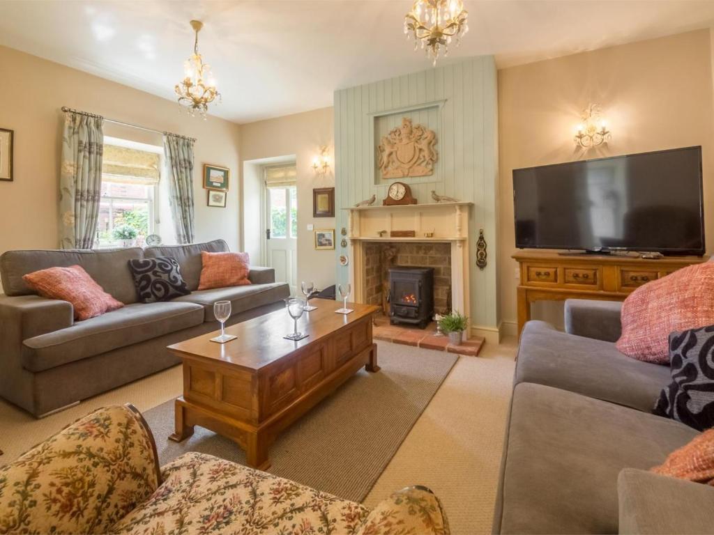 a living room with a fireplace and a television at 2 Bed in Dersingham oc-kt082 in Dersingham