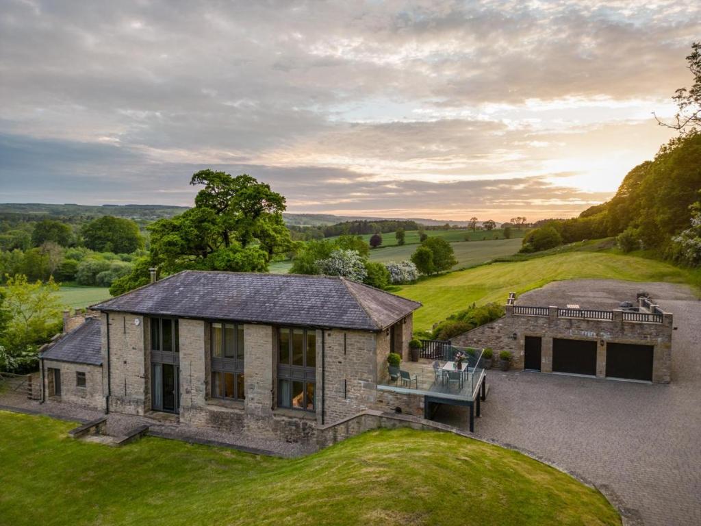 an exterior view of a stone house on a hill at 3 Bed in Richmond oc-86747 in Gilling