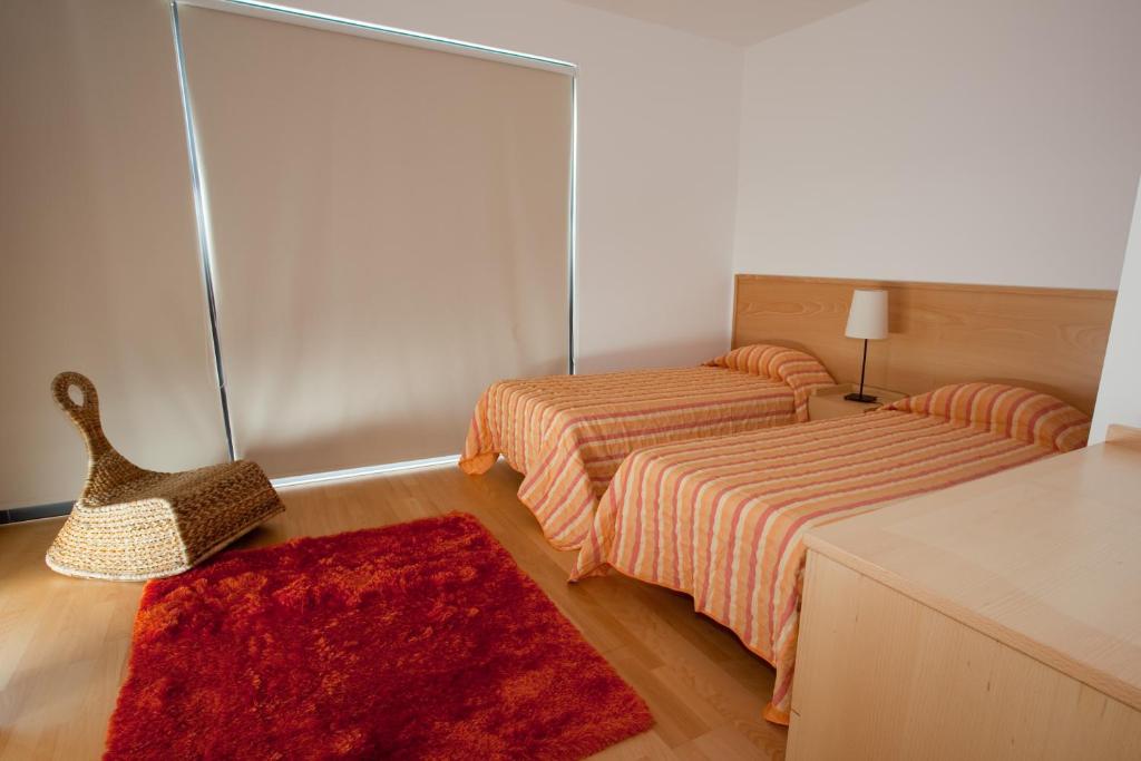 Postel nebo postele na pokoji v ubytování Cantinho das Buganvilias AT****
