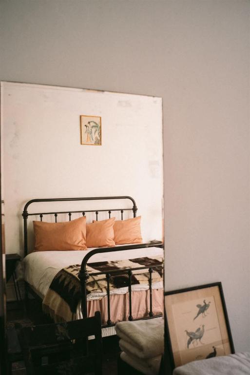 a bedroom with a bed with orange pillows on it at Object Hotel 1BR Shared Bath Room 2D in Bisbee