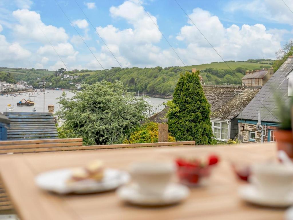 a table with plates of food on top of a balcony at 2 Bed in Fowey oc-91396 in Fowey