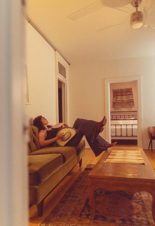 a man and woman sitting on a couch in a living room at Object Hotel 2BR Room 2G in Bisbee