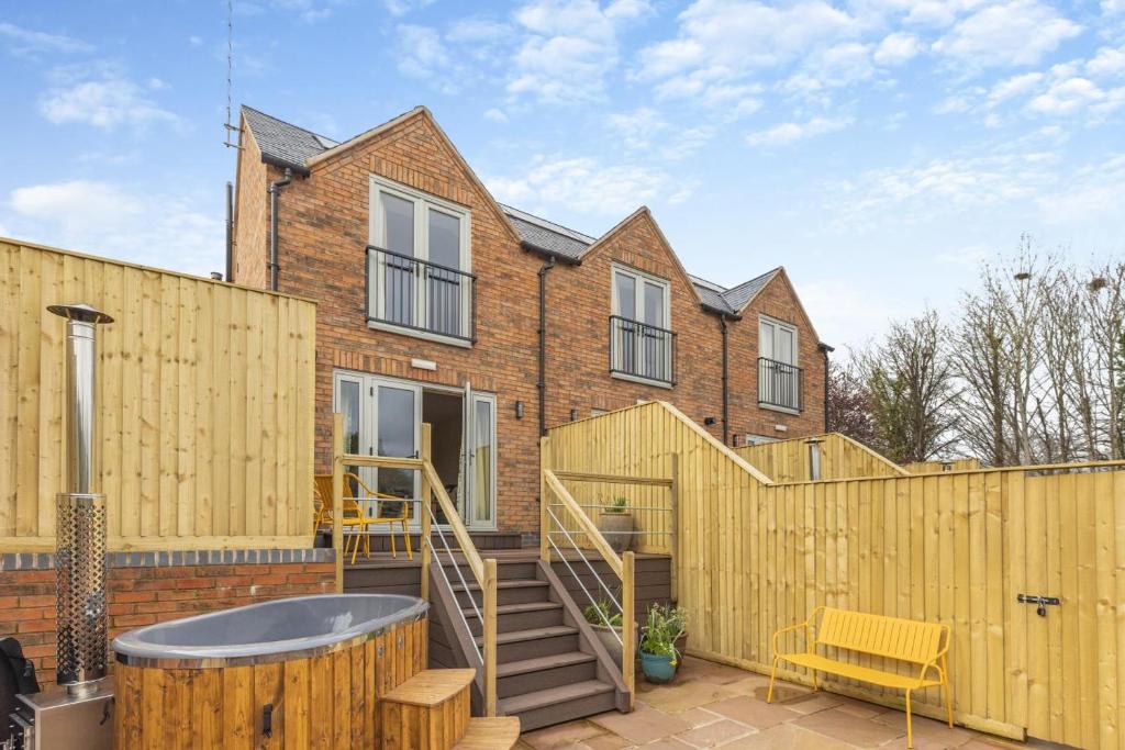 a house with a wooden fence and a hot tub at 1 Bed in Pershore oc-t29051 in Pershore
