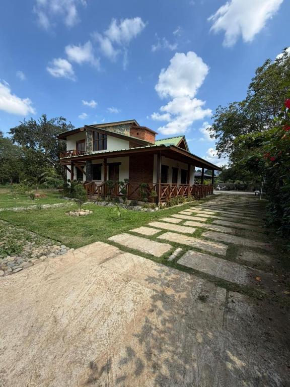 a house on the side of a dirt road at Villa Ana Rosa in Jarabacoa