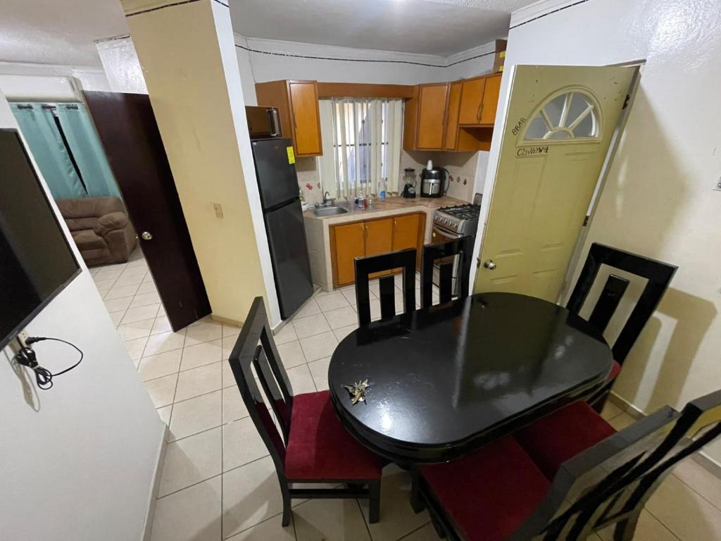 a kitchen and dining room with a table and chairs at casa renta vacacional en mazatlan in Mazatlán