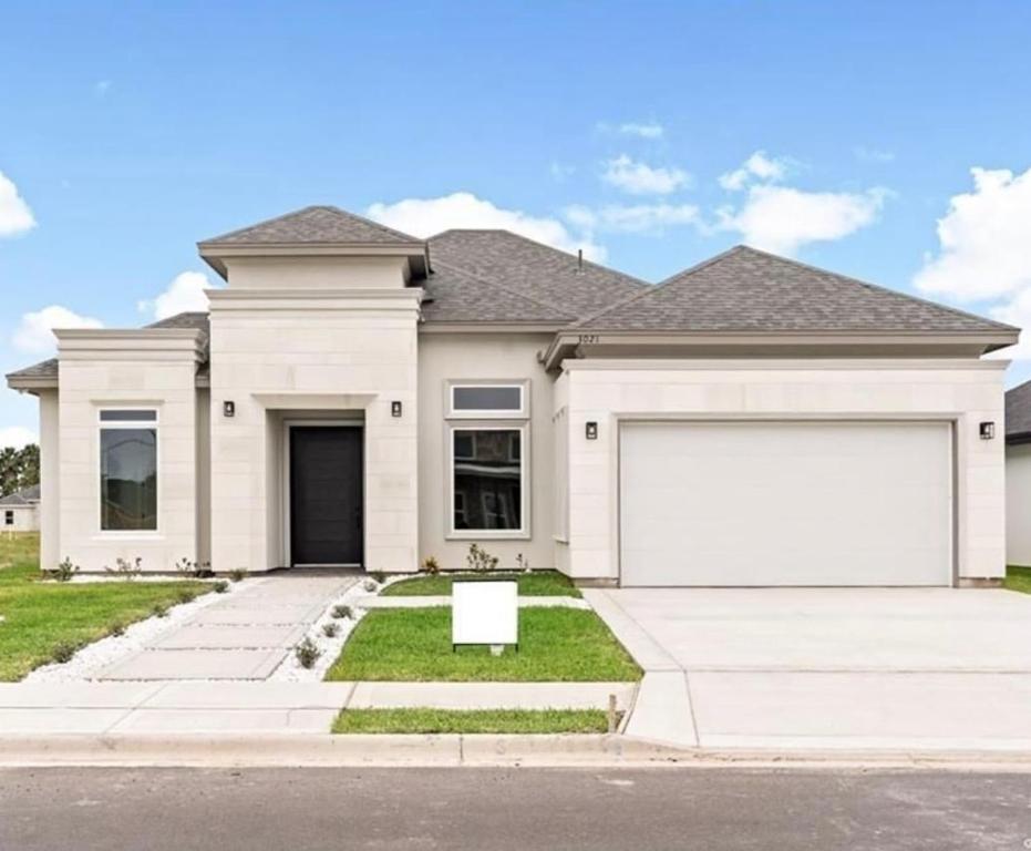a white house with a large white garage at Rabbit Run Home in Alton