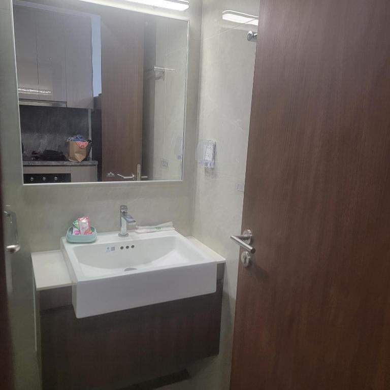a bathroom with a white sink and a mirror at H3 ocean park 1 in Gia Lâm Pho