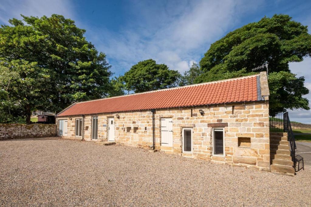 an old brick building with a red roof at 2 Bed in Danby oc-wa315 in Castleton