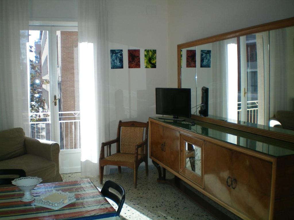 a living room with a dresser and a mirror at Gabri Apartment in Monopoli