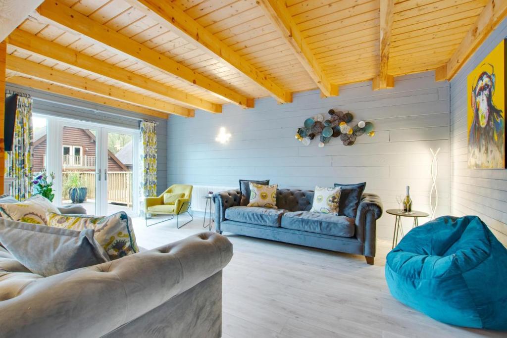 a living room with a blue couch and chairs at 4 Bed in Wadebridge oc-p00066 in Little Petherick