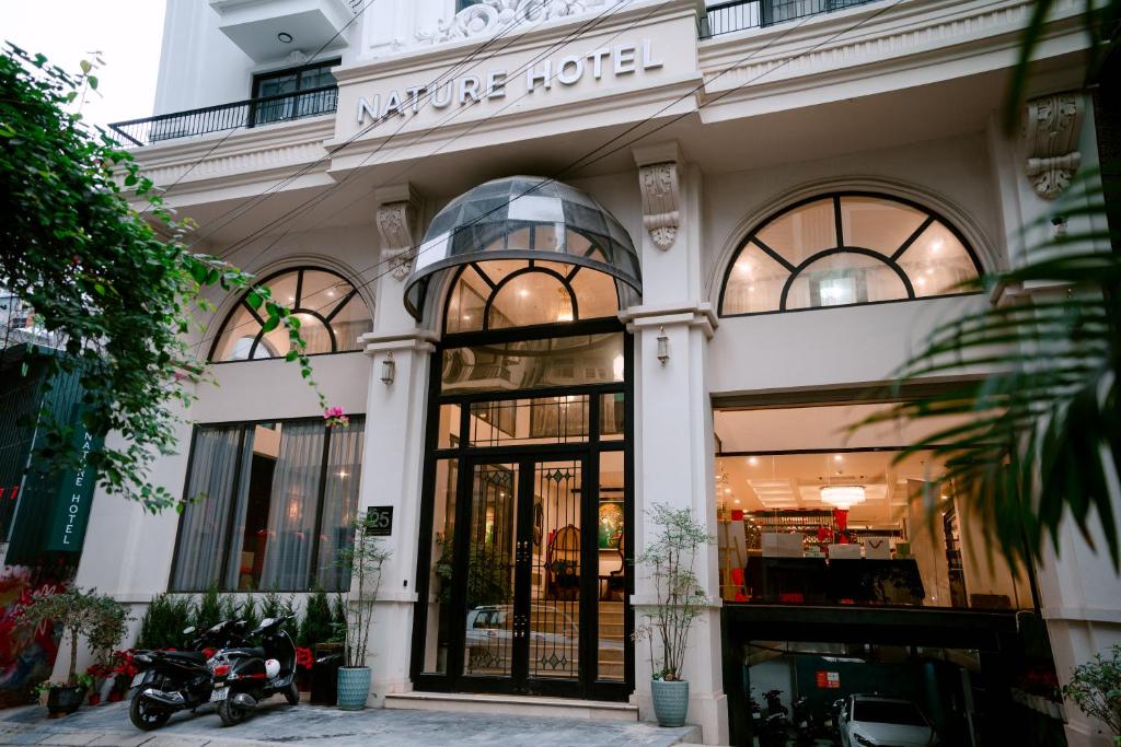 a store front of a building with windows at Nature Hotel and Spa Ha Noi in Hanoi