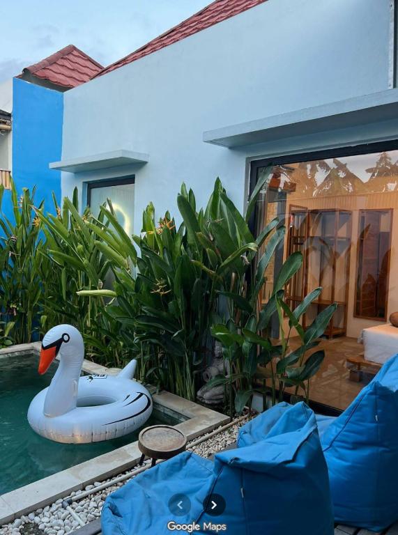 a swimming pool with a swan in the water at Peacock Private Pool Villa, self check-in, Workspace, Kitchen in Dalung