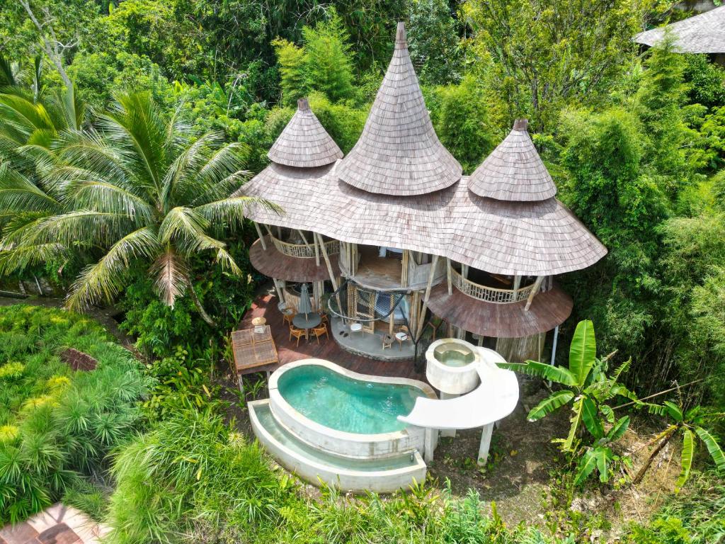 an aerial view of a resort with a swimming pool at Jiva Bali - Inaya in Selat