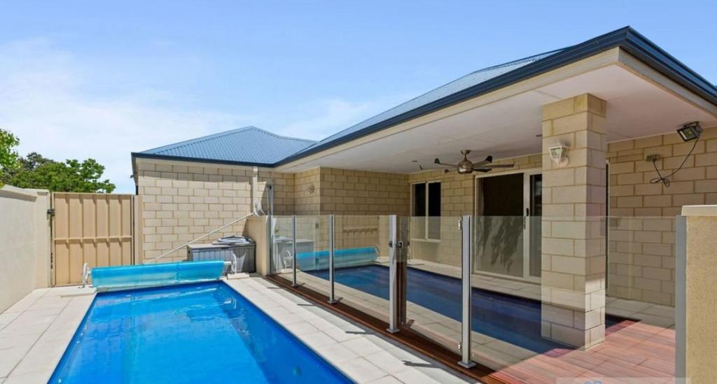 a swimming pool in the backyard of a house at Premium Large Cosy Home with Private Pool in Perth