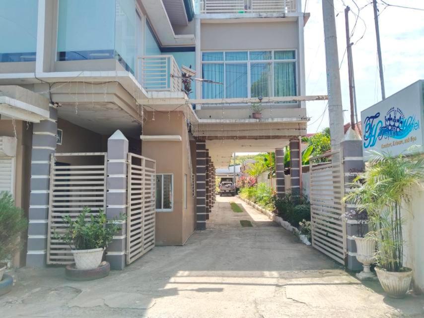a building with a walkway in front of it at Tayud Hotel by Hiverooms in Liloan