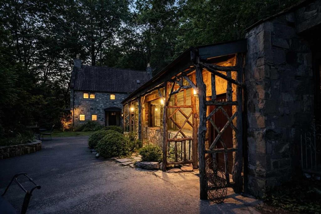 a barn with a gate in front of a house at Honeymoon Cottage Chateau DuMont in Banner Elk