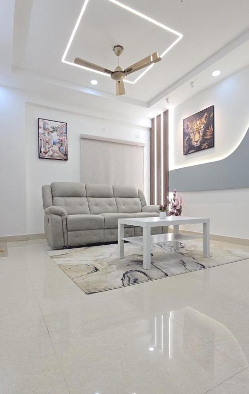 a living room with a couch and a table at 3bhk Near kodapur-Hitex Exhibition&Shilparamam Art in Hyderabad