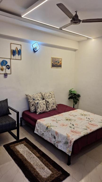a bedroom with a bed and a ceiling fan at Urban Cozy 2 bhk in Ghaziabad