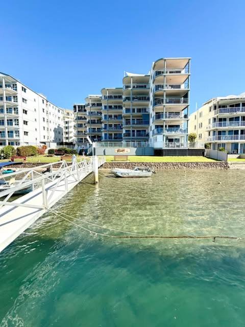 a large body of water with buildings in the background at On The River Apartments in Maroochydore
