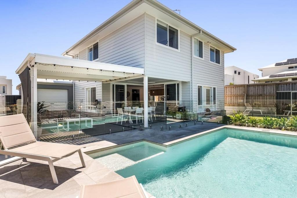 a house with a swimming pool in front of a house at Sunhaven in North Creek
