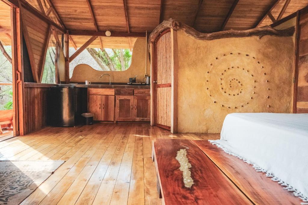 a bedroom with a bed and a sink in it at Alya Jungle Casitas in San Juanillo