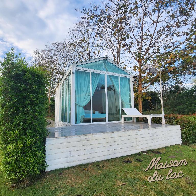 a gazebo with a bench on a deck at Maison Du Lac The Panoramic Glass Lodge in Wang Nam Khieo