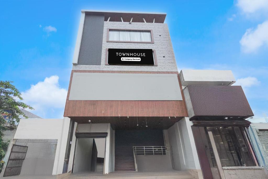 a tall building with a sign on it at Super Townhouse DSIDC Bawana Formerly Kanhaiya Residency in Delhi