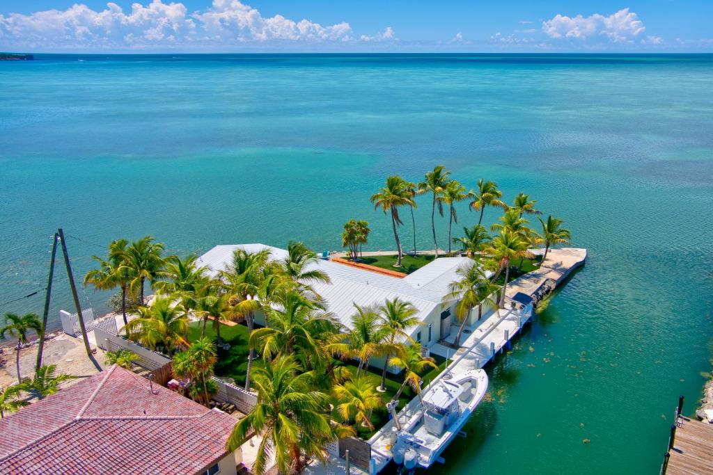an aerial view of a resort with palm trees and the ocean at NEW!Paradise PointVIEWS!Open WaterDockPool! in Marathon