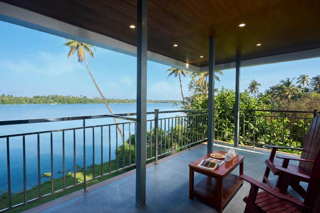 a balcony with a view of the ocean at Akanta Cherai Beach Resort in Cochin