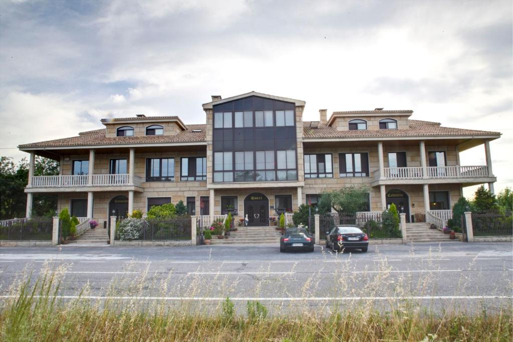 a large building with cars parked in front of it at Pazo de Monterrei in Ourense