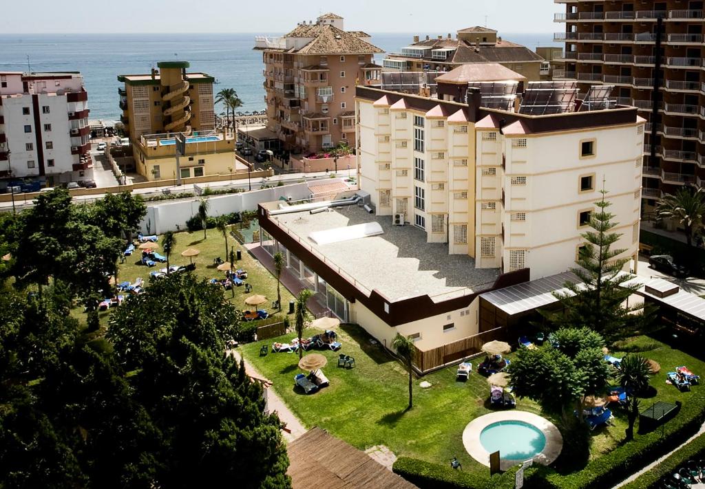 una vista aérea de un edificio con un parque frente al océano en Hotel Monarque Cendrillón, en Fuengirola