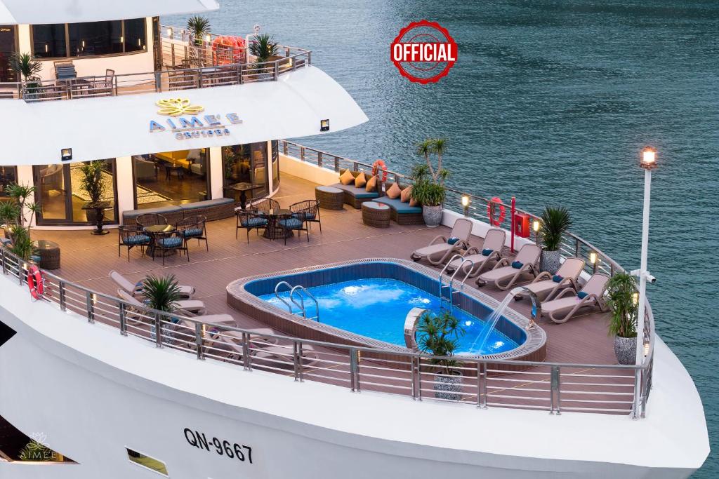 an image of a cruise ship deck with a swimming pool at AIME'E CRUISES - Halong Bay in Ha Long
