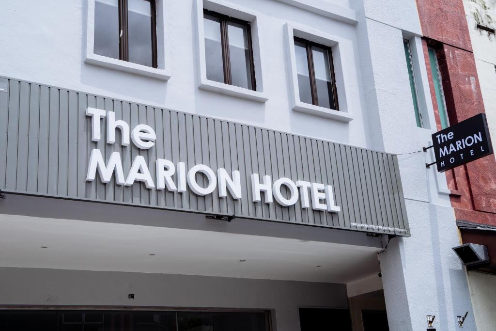 a sign for the marion hotel on the front of a building at The Marion Hotel Impian Emas Branch in Skudai