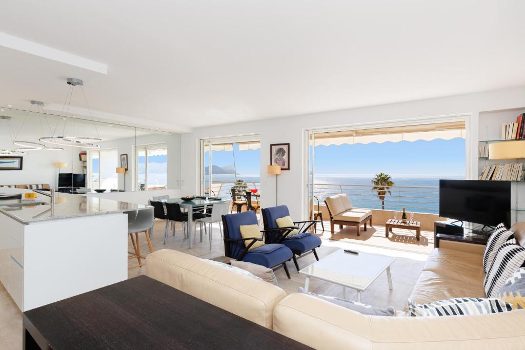 a living room with a view of the ocean at Mer du Sud 4 YourHostHelper in Cannes