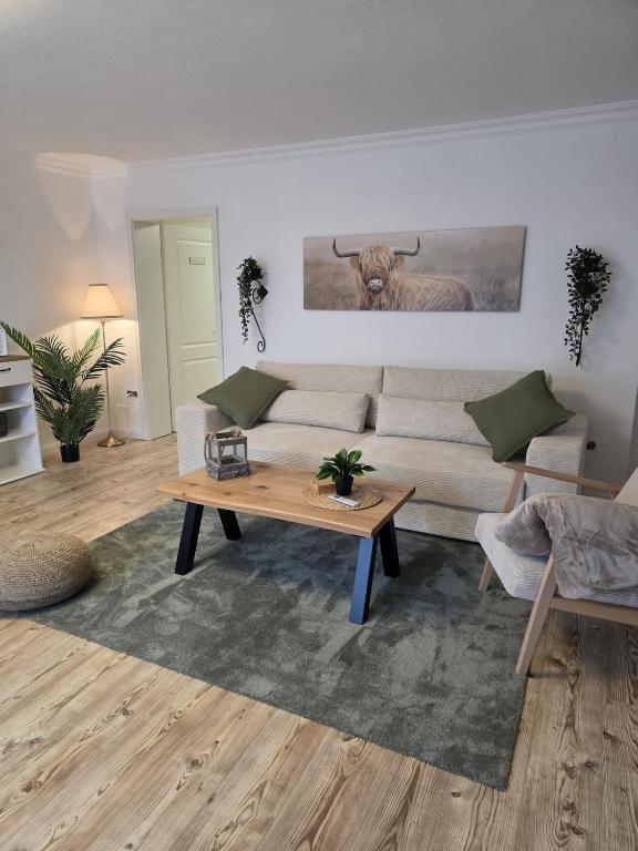 a living room with a couch and a table at Blick zur Burg in Nörten-Hardenberg