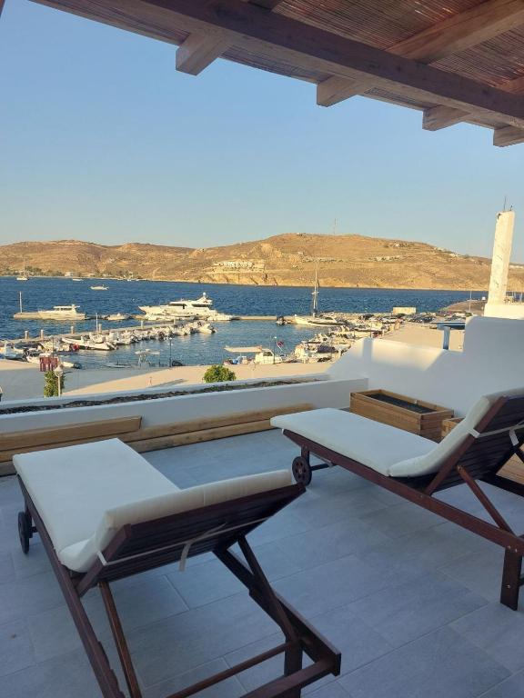 a patio with chairs and a view of a marina at Puerto Serifos in Livadi