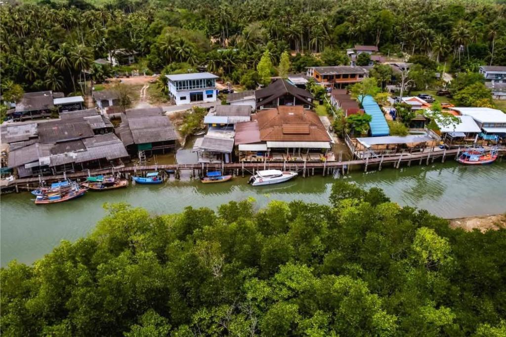 an aerial view of a dock with boats in the water at The Mangrove Hideaway Kohchang in Ko Chang
