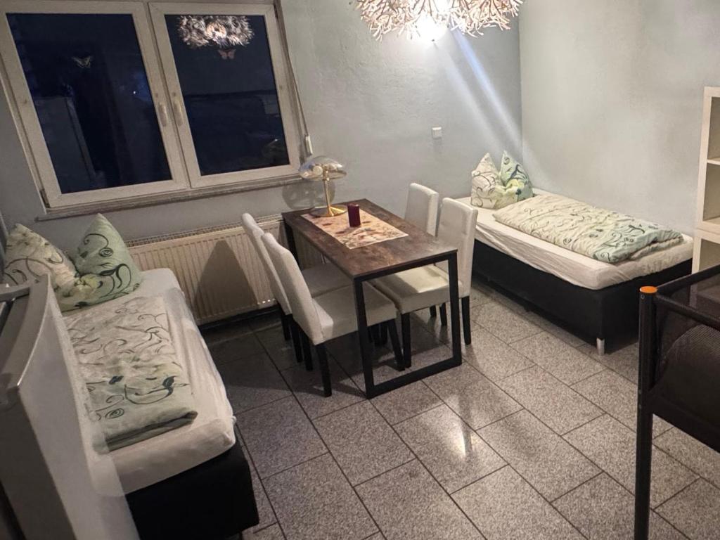 a room with a table and a bed and a table and chairs at Bauernhof Privatzimmer Free WiFi Gemeinschaftsbad in Hausbreitenbach