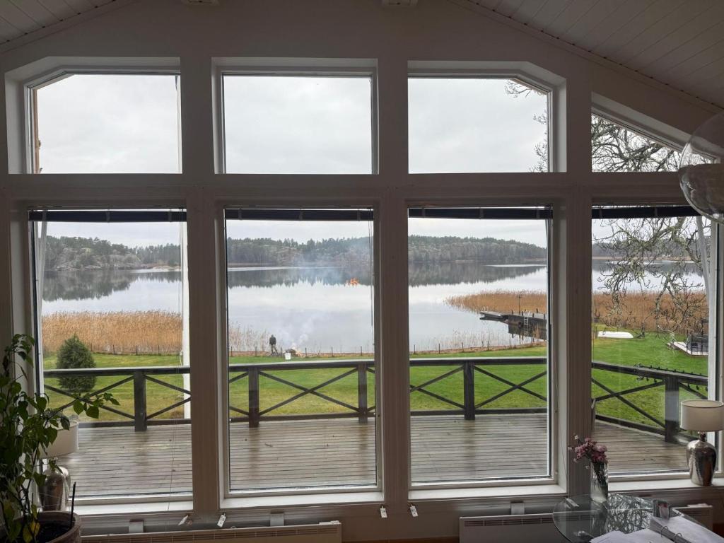 a room with a large window looking out at a lake at Privat strandvilla i vackra Geta in Geta