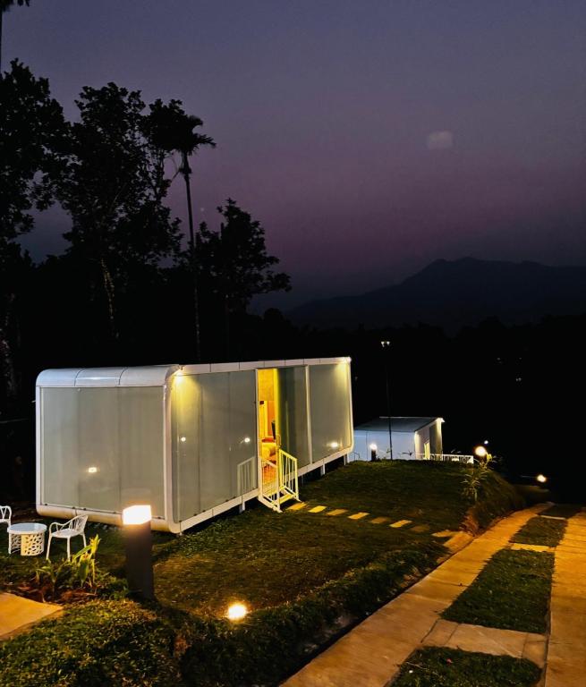 a large white tent in a yard at night at West wind Resort in Meppādi