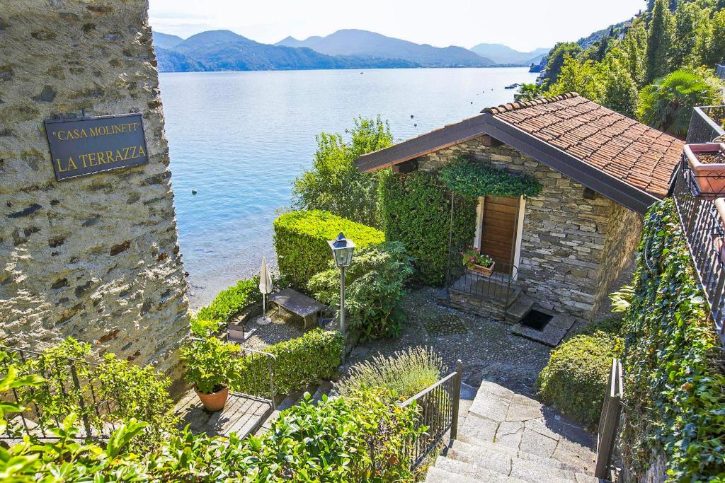 a small building next to a large body of water at Casa La Terrazza Uno C in Cannobio