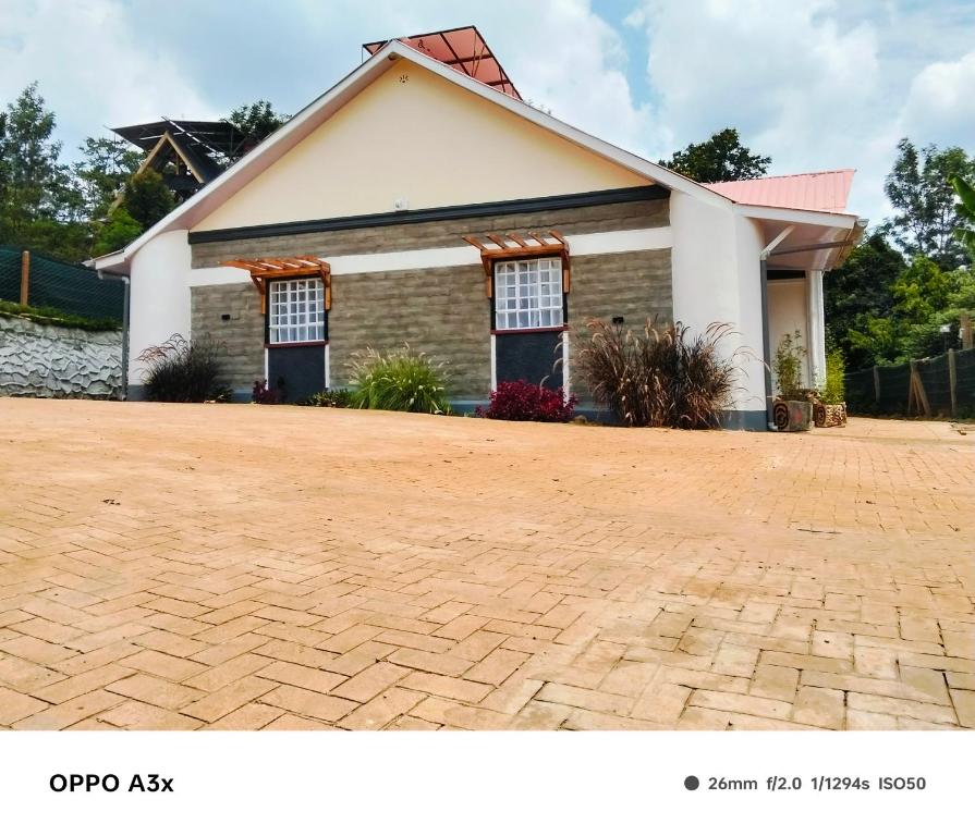 a house with a brick driveway in front of it at Marine waters retreat Block A in Embu
