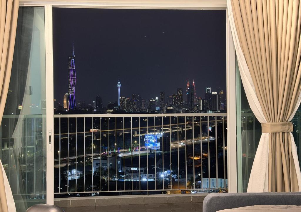 a view of a city at night from a window at K&L Suites Razak City Kuala Lumpur in Kuala Lumpur