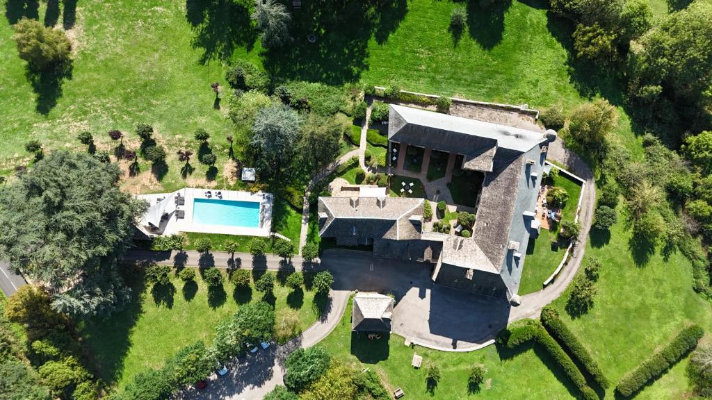 an aerial view of a house with a swimming pool at Château de la Falque, The Originals Relais in Saint-Geniez-dʼOlt
