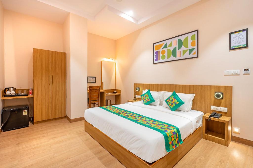 a bedroom with a large bed in a room at Treebo Alfa Suites in Mumbai