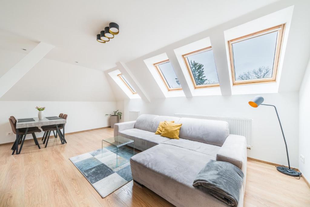 a living room with a couch and a table at Apartmán VALORI - 100m2 in Poděbrady