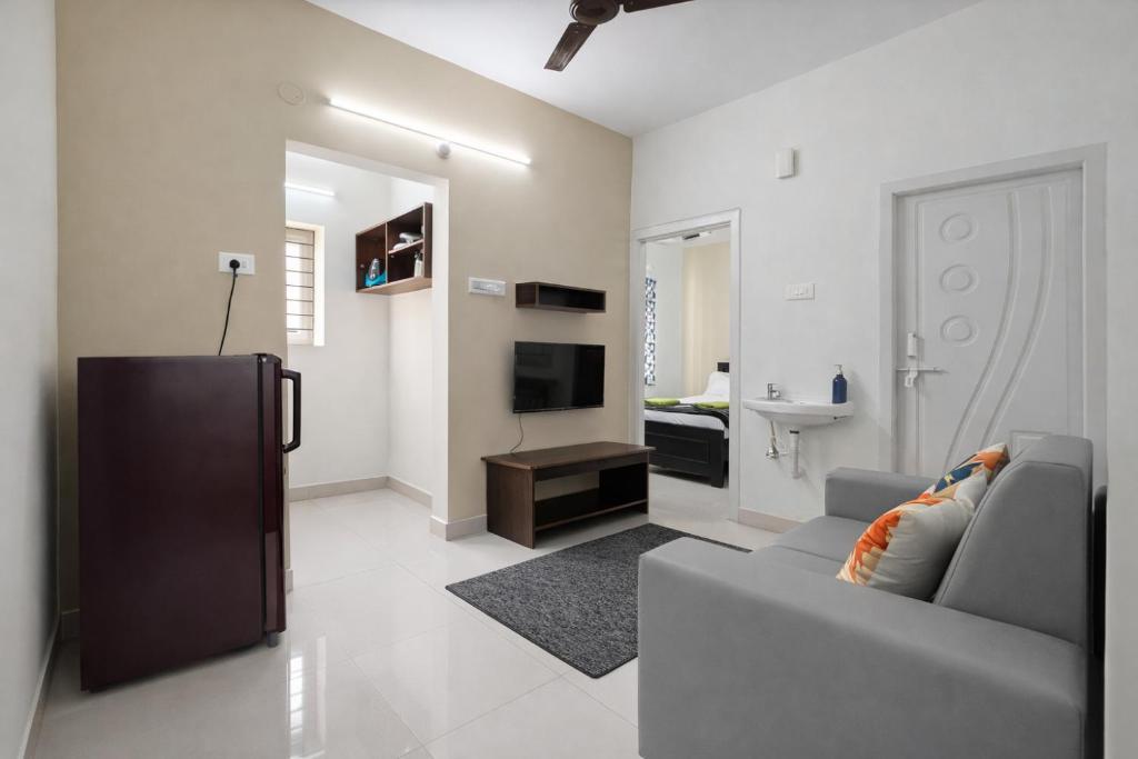 a living room with a couch and a television at Prakash Nilayam Studio I - Kondapur in Lingampalli