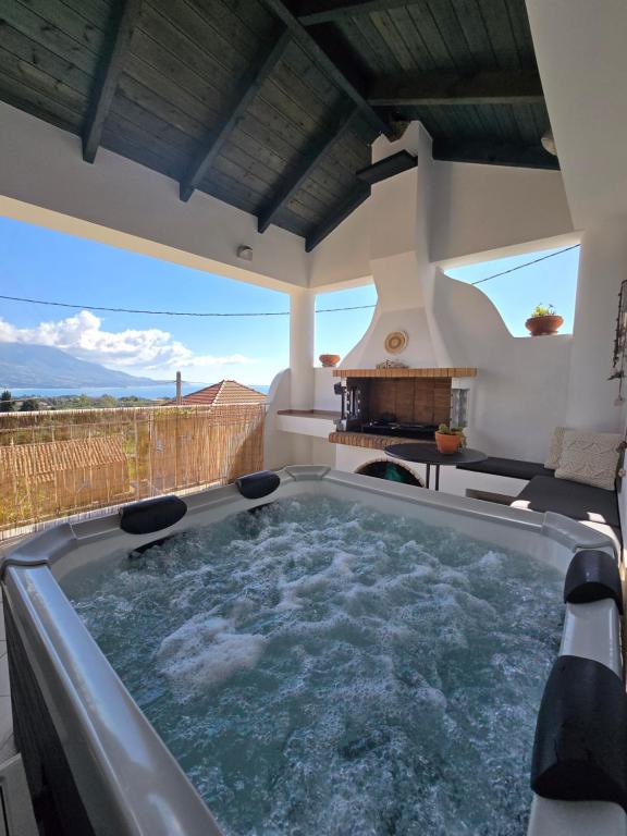 a hot tub on the patio of a house at Marily's seaview suite with private JACUZZI and BBQ in Spartià
