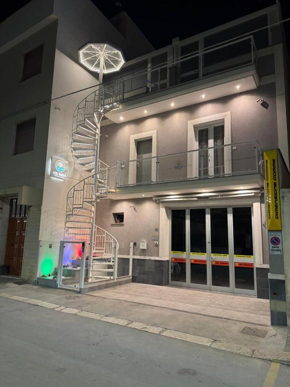 a building with a spiral staircase on the side of it at Lux Maris in Mazara del Vallo