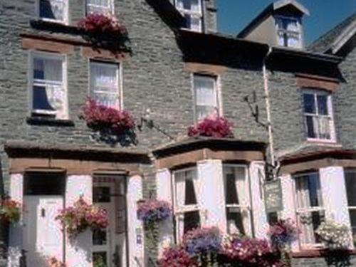 a large brick house with flowers on the windows at Lindisfarne House in Keswick